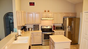 A kitchen with white cabinets, stainless steel appliances, a sink, and a 'No Smoking' sign. - Jacksonville Vacation (Jacksonville)