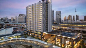 A high-rise hotel with a modern design, featuring a prominent clock tower and multiple balconies. - DoubleTree by Hilton Tokyo Ariake (Tokyo)