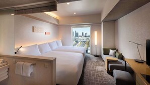 A hotel room with two beds, a sofa, a desk, and a TV. - DoubleTree by Hilton Tokyo Ariake (Tokyo)