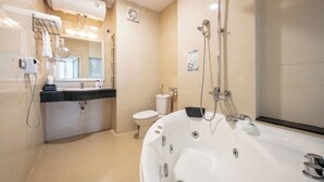 A modern bathroom with a large bathtub, a toilet, and a sink with a mirror. - A25 Hotel - Dich Vong Hau (Hanoi)