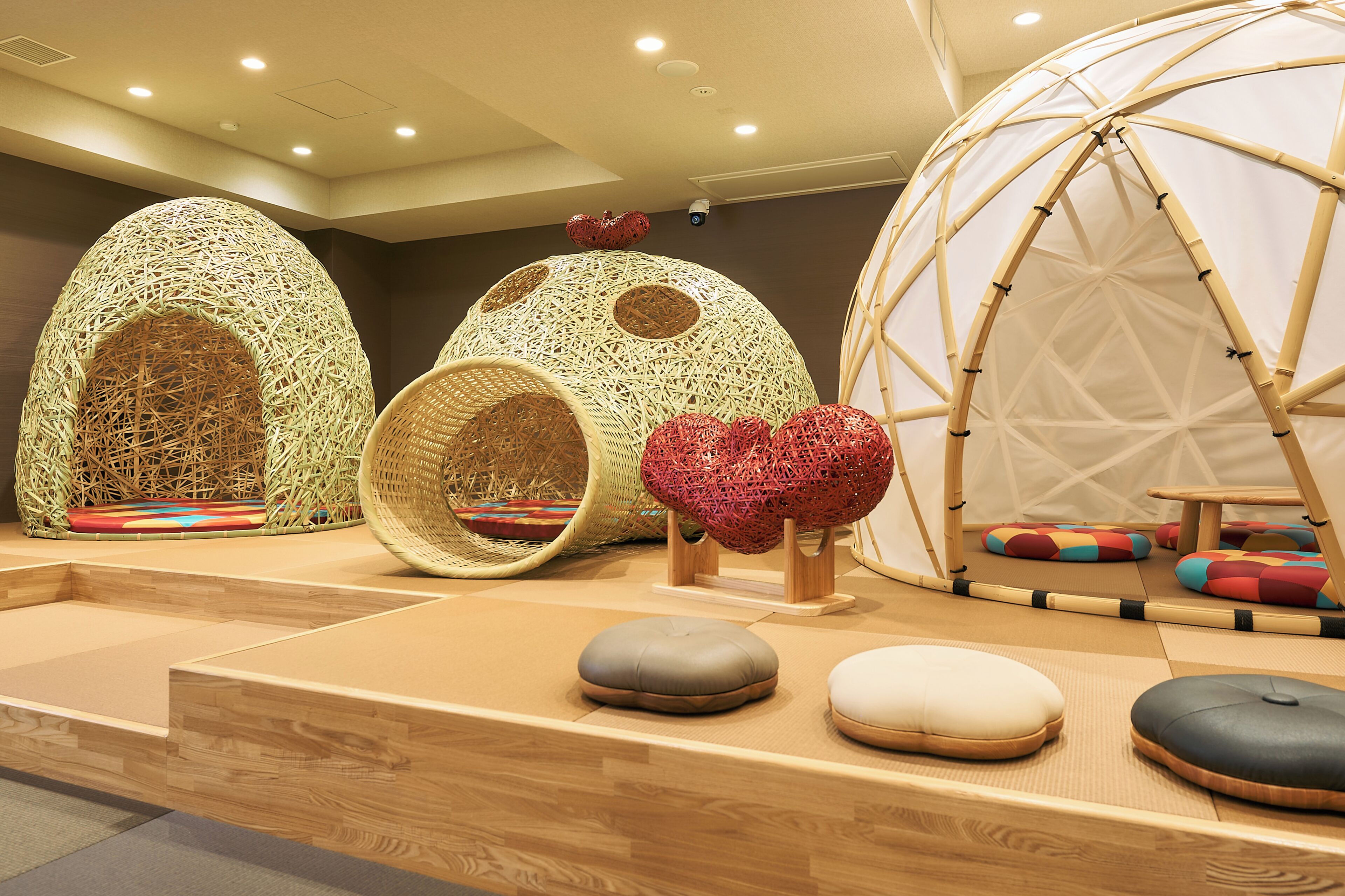 A room with unique spherical structures, a large dome, and various seating options.