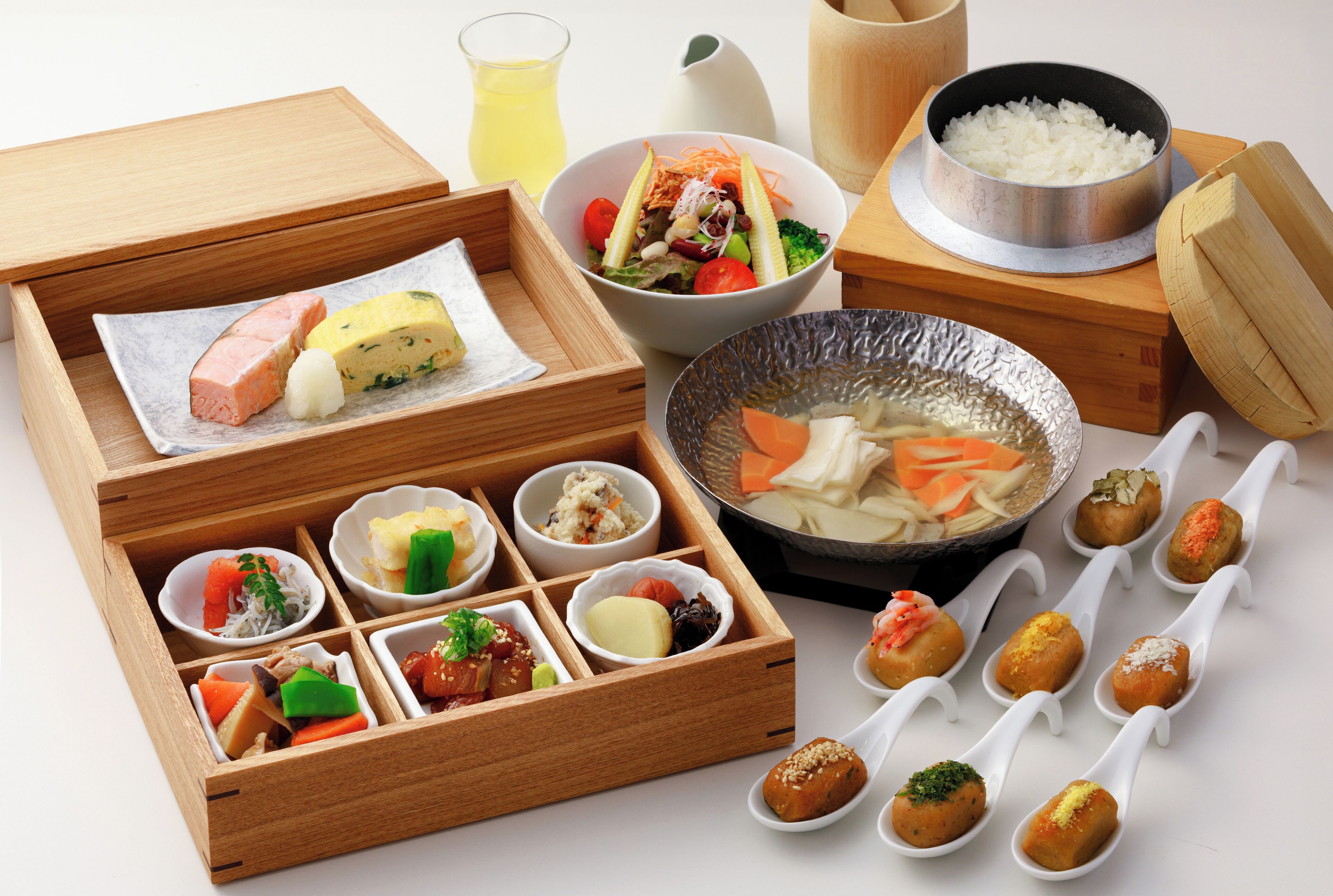 A variety of Japanese dishes arranged on a table, including sushi, rice, and soup.
