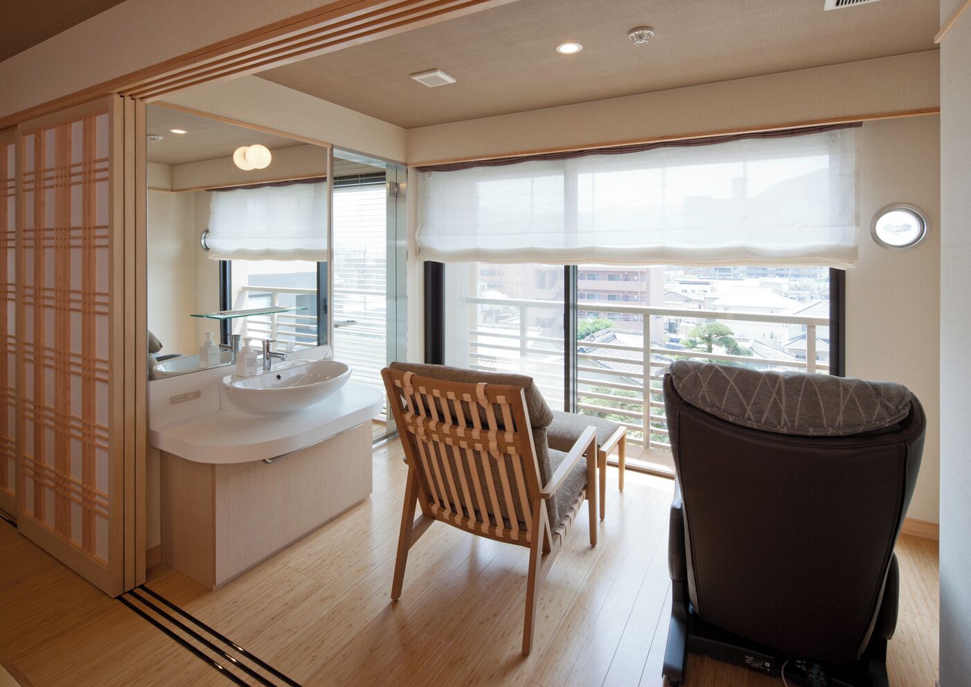 A modern bathroom with a sink, mirror, and wooden floor.