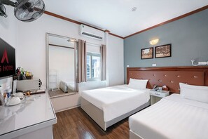 A hotel room with two beds, a desk with a mirror, and a window with curtains. - A25 Hotel - 185 - 187 Lo Duc (Hanoi)