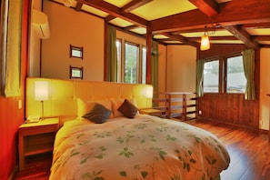 A bedroom with a large bed, wooden headboard, bedside tables with lamps, and a window with curtains. - One More Time Heart (Nikko)
