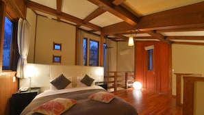 A bedroom with a wooden ceiling, a bed with multiple pillows, a nightstand with a phone, and a window with curtains. - One More Time Heart (Nikko)