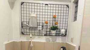 A compact kitchen with a sink, a kettle, and a small refrigerator. - Pension Inn Marilao (Marilao)