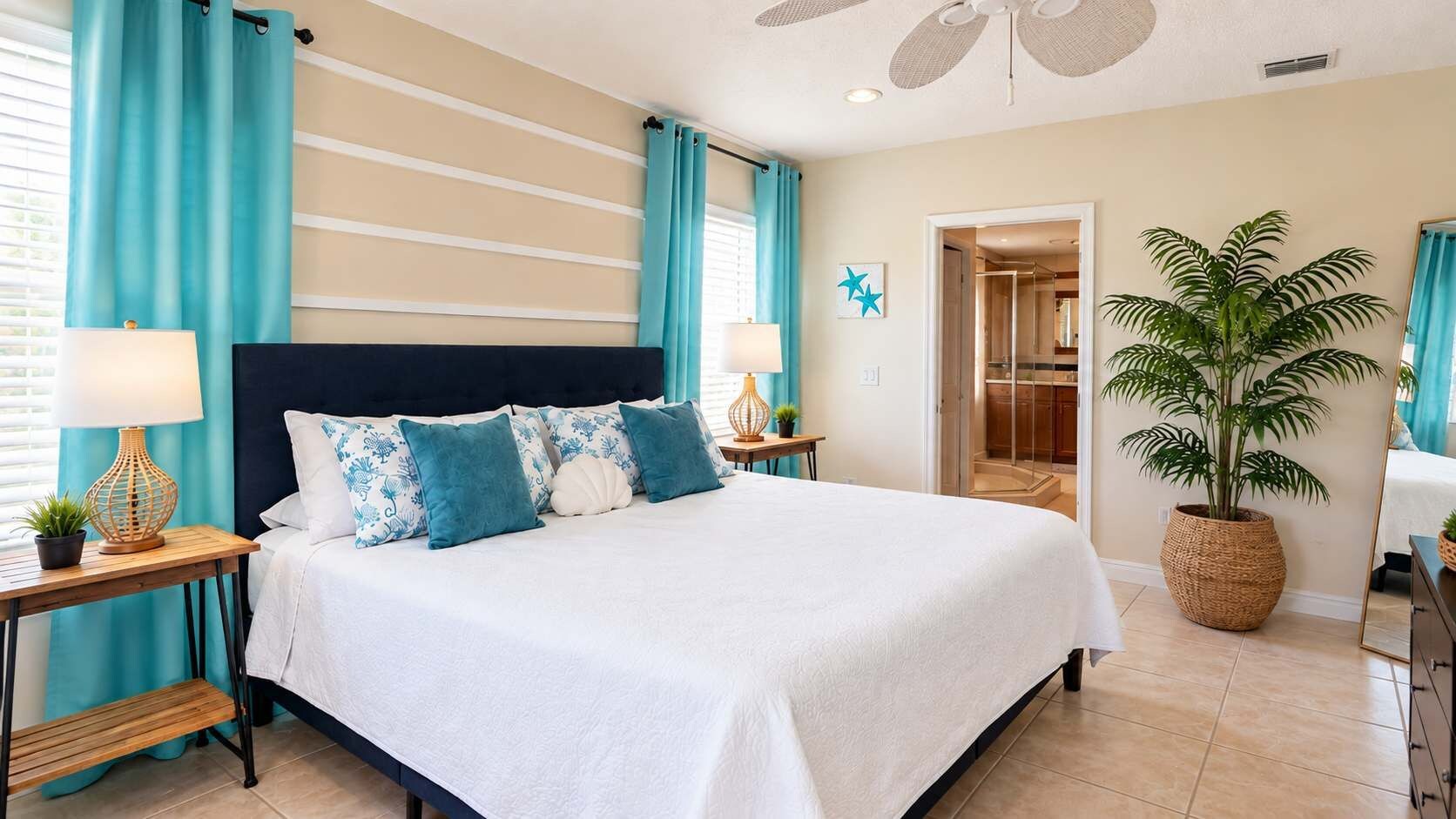 A bedroom with a large bed, a nightstand with a lamp, a potted plant, and a mirror.