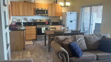 A compact living space with a kitchen, dining area, and seating area.