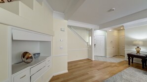 A spacious hallway with a wooden floor, a staircase, and a door leading to another room. - Why Stay in the confinement of a hotel, when Ucan stay in this Las Vegas Oasis. (Las Vegas)