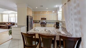 A modern kitchen with a central island, built-in appliances, and a dining area with chairs. - Why Stay in the confinement of a hotel, when Ucan stay in this Las Vegas Oasis. (Las Vegas)