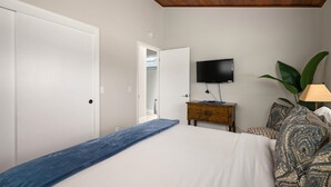 A bedroom with a bed, a dresser, a television, and a plant. - Sea'Scape : 2  BR, 2  BA House in Cambria, Sleeps 4 (Cambria)