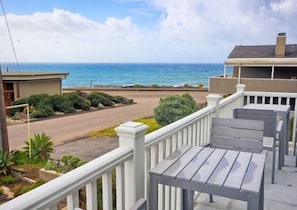 Enjoy ocean views from the balcony, surrounded by a well-manicured lawn and serene beach scenery.