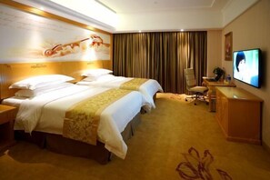 A hotel room with two beds, a desk, a chair, a television, and a large window with curtains. - Vienna Hotel (Shanghai Hongqiao International Exhibition Center Huaxin) (Shanghai)