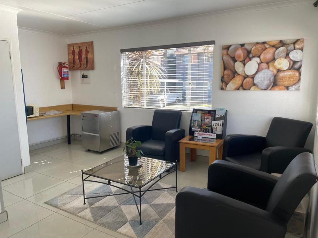 A waiting area with a reception desk, a coffee table, and seating.