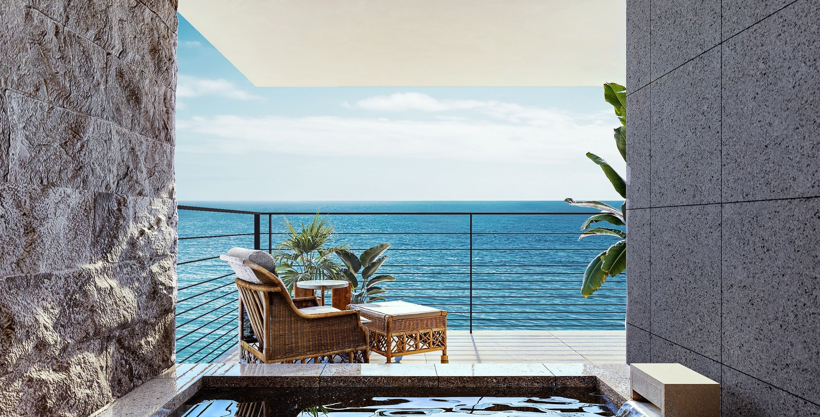 A balcony with wicker furniture overlooking a body of water.