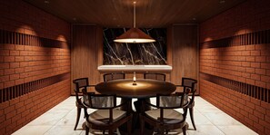 A round dining table with six chairs, a marble backsplash, and a hanging pendant light. - UMITO ATAMI HONTEI　 (Atami)
