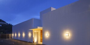 A modern building with a flat facade, multiple entry points, and exterior lighting. - UMITO ATAMI HONTEI　 (Atami)