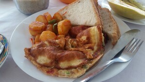 A plate with fried eggs, hash browns, and toast. - St. Gotthard Motel Bar & Restaurant (Malindi)
