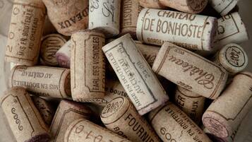 A collection of vintage wine corks with inscriptions.