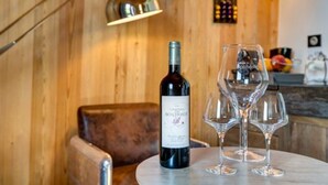 A bottle of wine and two glasses on a table in a wooden room. - Coup 2 Foudres (Saint-Jean-de-Blaignac)