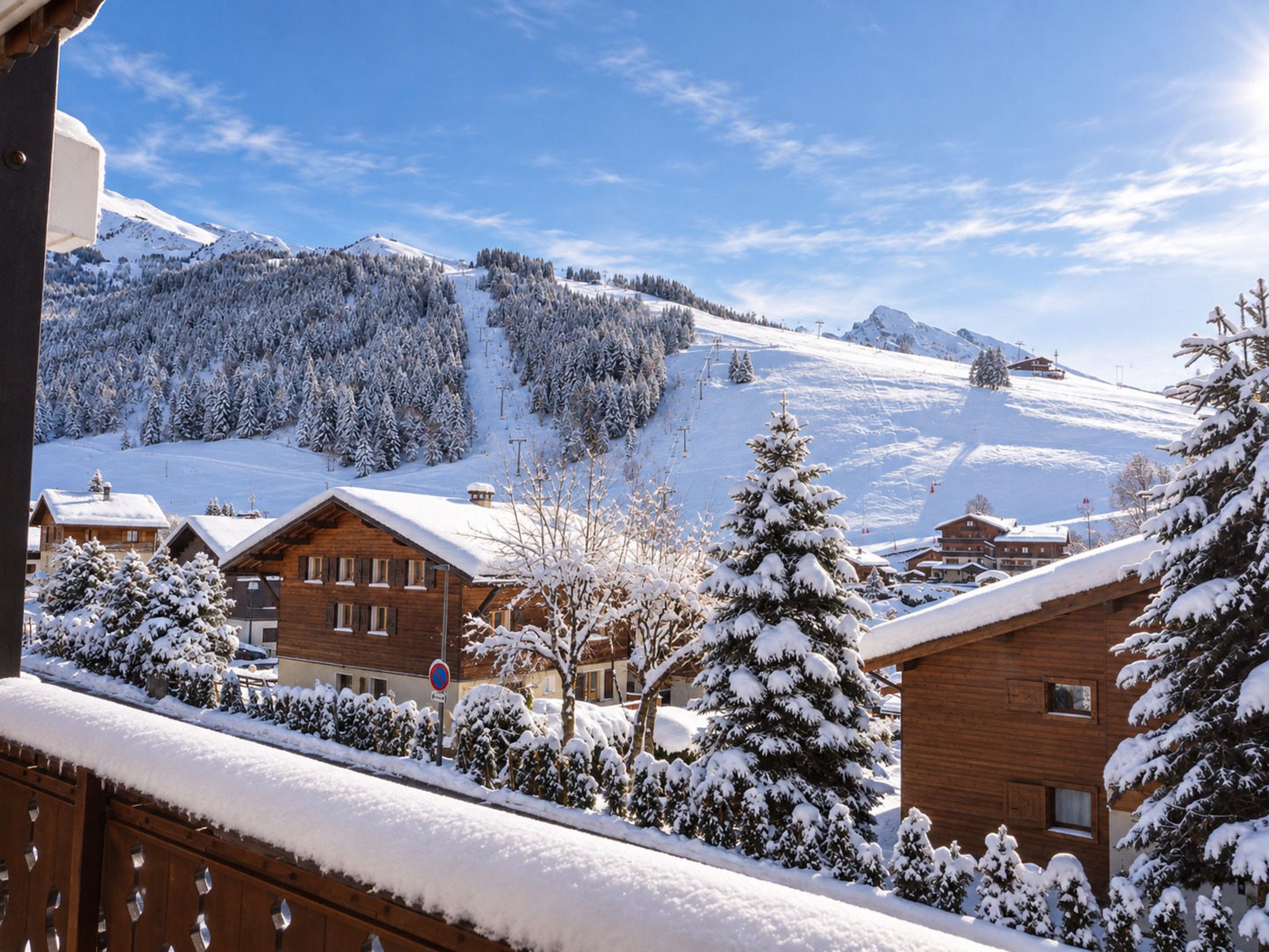 A snowy mountain village with wooden buildings and a clear sky.