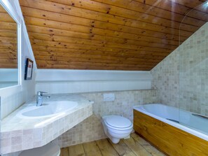 A bathroom with a wooden ceiling, a sink, a toilet, and a bathtub. - Chalet near slopes, fireplace, pets allowed, garage, WIFI (La Clusaz)