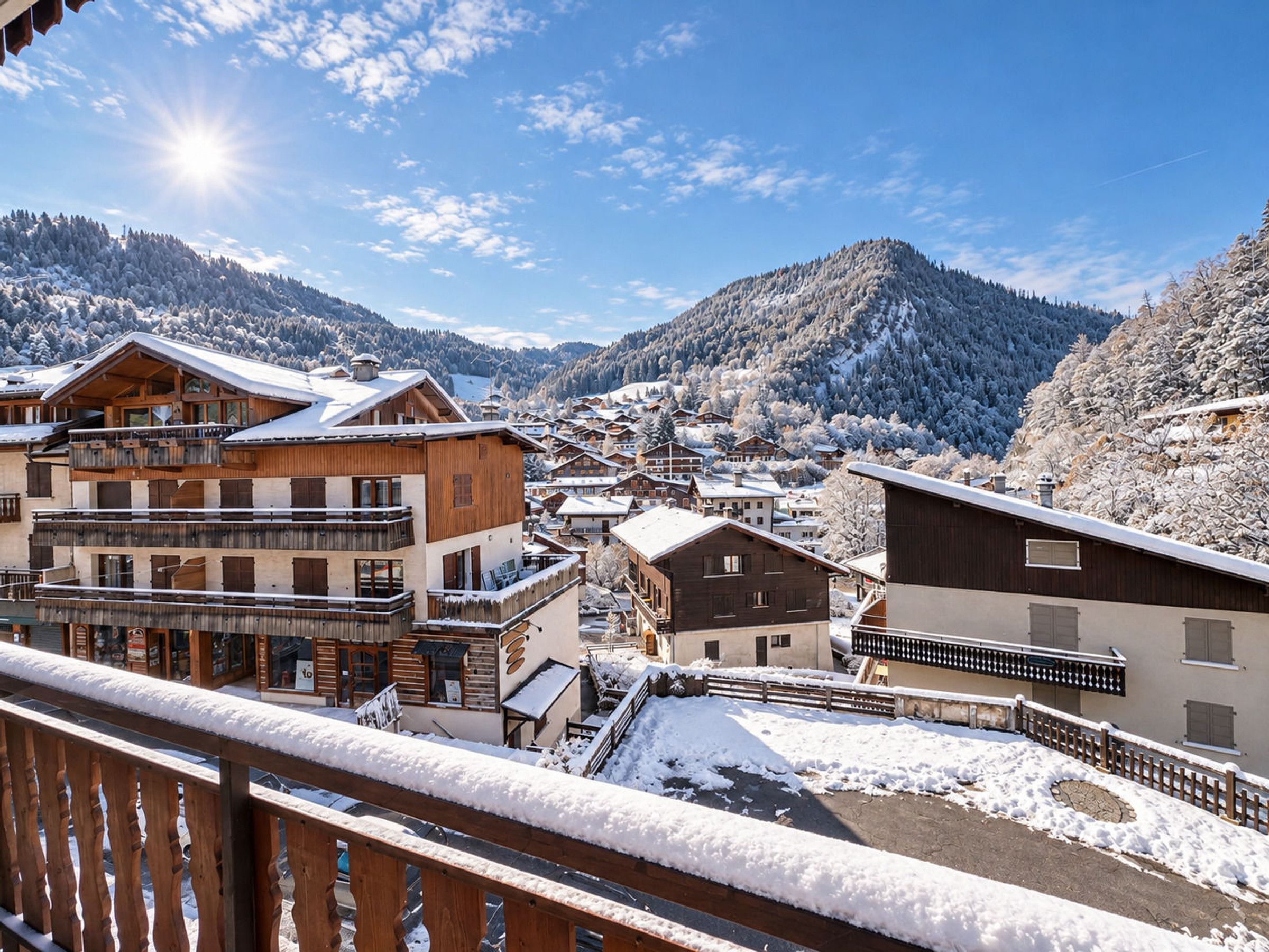 A snow-covered mountain village with wooden buildings, a balcony, and a clear sky.