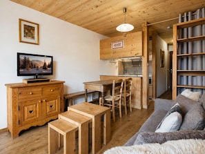 A wooden interior with a TV, wooden furniture, a kitchen, and a sofa. - Cozy studio for 3 guests, near slopes and shops (La Clusaz)