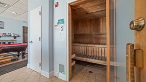 A room with a pool table, a sauna, and a door leading to another area. - NEWLY UPDATED FURNITURE! | Outdoor Pool | Hot Tub | Sauna | BEACHBALL PROPERTIES (Gulf Shores)