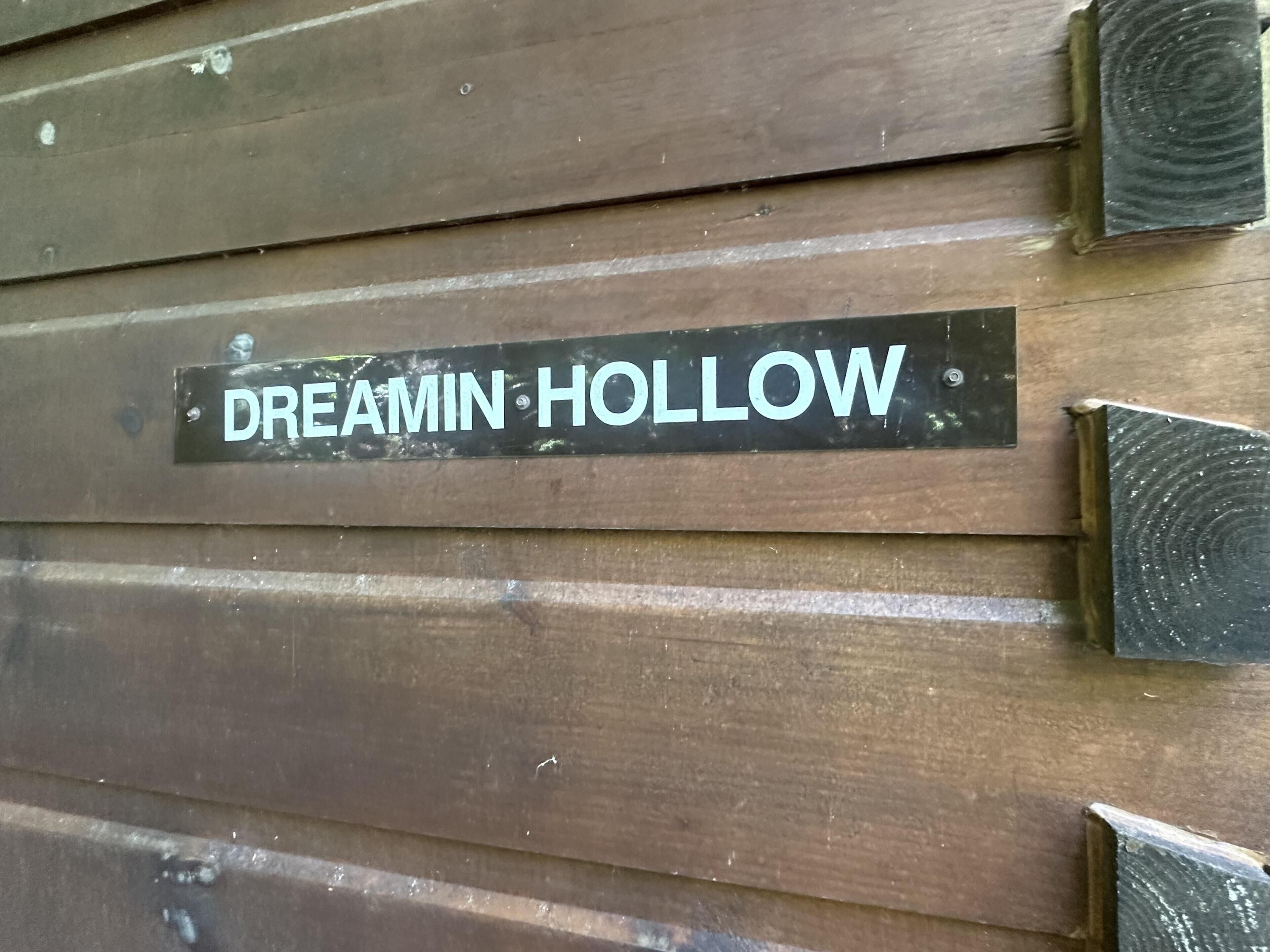 A wooden wall with a sign that reads 'DREAMIN HOLLOW.'