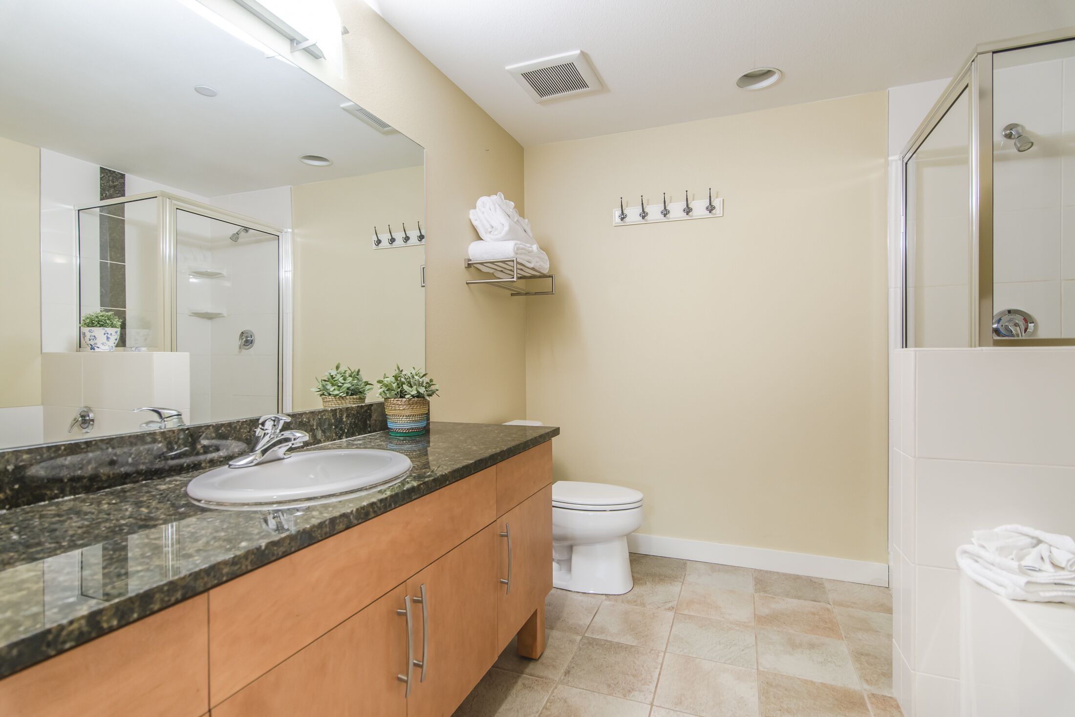 A bathroom with a sink, toilet, and shower.