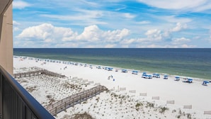 A beach with white sand, blue umbrellas, and a wooden boardwalk. - DIRECT GULF FRONT UNIT, INCREDIBLE UNCROWDED BEACHES, CONVENIENT LOCATION (Orange Beach)