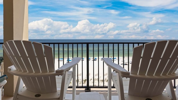 Two white Adirondack chairs facing a beach with a clear sky and ocean view. - DIRECT GULF FRONT UNIT, INCREDIBLE UNCROWDED BEACHES, CONVENIENT LOCATION (Orange Beach)