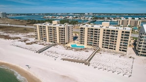 A high-rise hotel with multiple balconies, a swimming pool, and a beach area. - DIRECT GULF FRONT UNIT, INCREDIBLE UNCROWDED BEACHES, CONVENIENT LOCATION (Orange Beach)