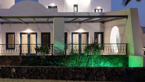 A hotel with a white facade, multiple balconies, and a sign reading "Trisheni". - Tristhenia Hotel (Santorini)