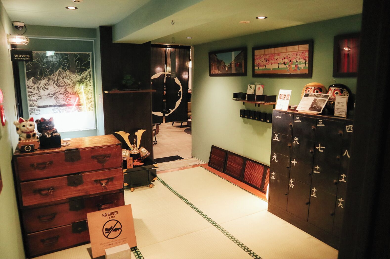 A traditional Japanese room with tatami flooring, a sliding door, and a cabinet with numbered drawers.