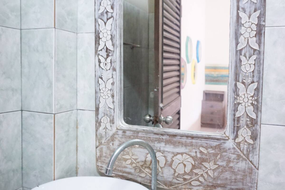 bike room - twin bed | bathroom sink