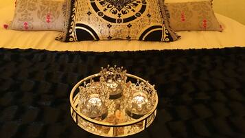 A bed with patterned pillows and a decorative tray with crystal-like objects.