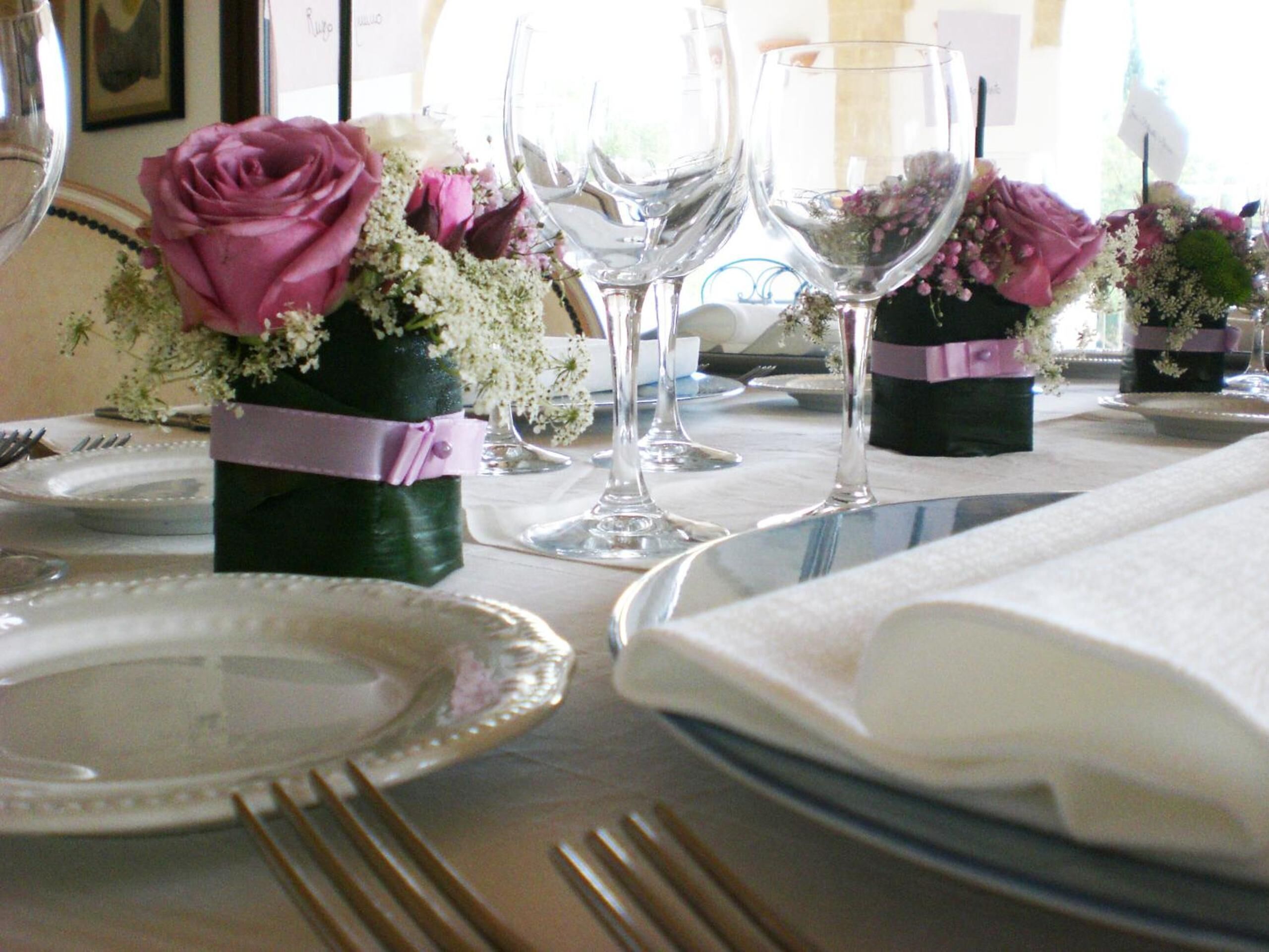 A table set for a formal event with clear glassware, plates, and cutlery.