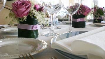 A table set for a formal event with clear glassware, plates, and cutlery.