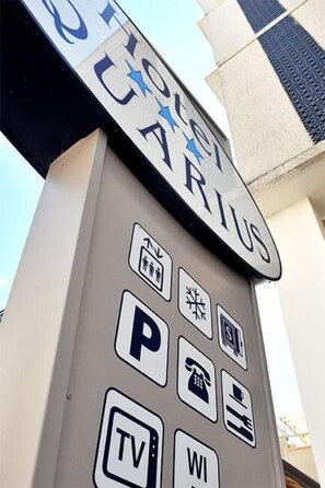 A sign with the word "TOILET" and various icons indicating amenities such as parking, a phone, and a TV. - Hotel Aquarius (Cattolica)