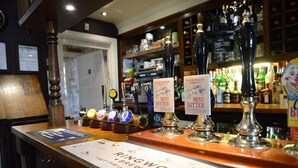 A bar counter with multiple beer taps labeled "Ringwood Best Bitter" and a sign indicating "Ringwood Brewery". - The Flying Bull Inn (Liss)