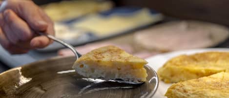 A slice of quiche on a ceramic plate.
