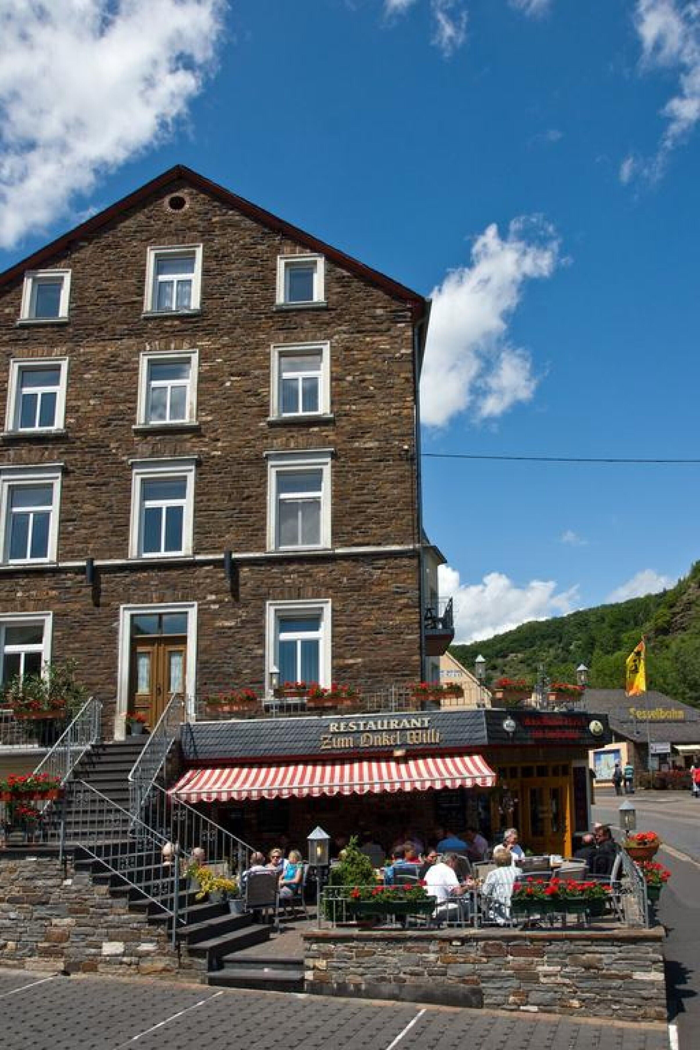 A stone building with a restaurant on the ground floor.