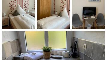 A hotel room with a bed, a desk with a TV, and a bathroom with a window, towel, and toiletries.