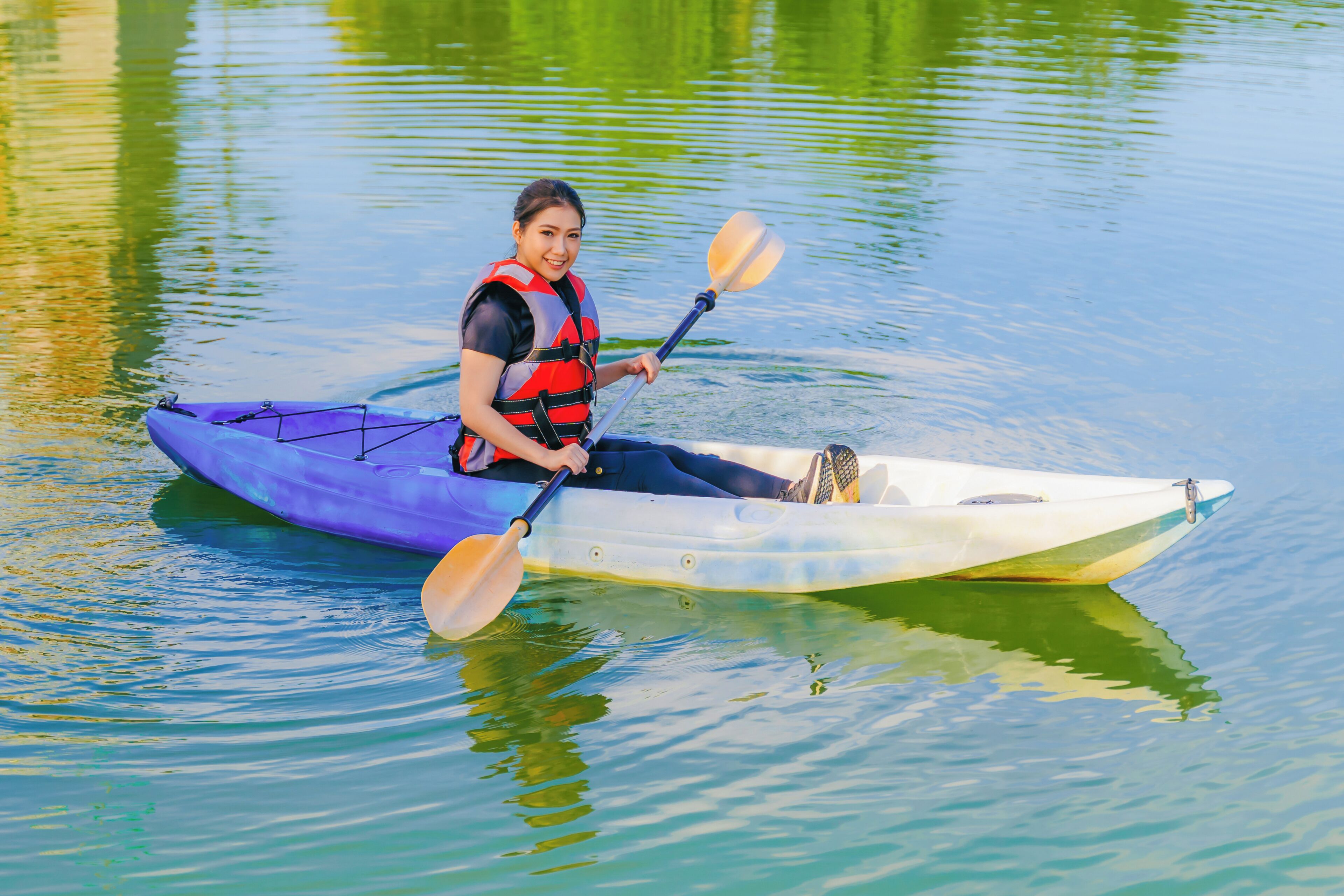 A person in a kayak on calm water.