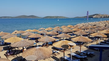 On the beach, sun-loungers, beach umbrellas, beach towels