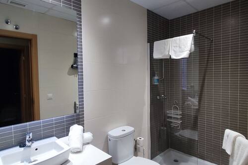 Familie appartement | Badkamer | Een douche, een regendouche, een haardroger, handdoeken