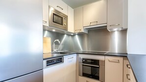 A modern kitchen with stainless steel appliances, a built-in oven, and a dishwasher.